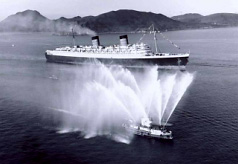 The Alexander Grantham puts on a welcoming water spray performance as the Seawise University enters Hong Kong waters in 1971.